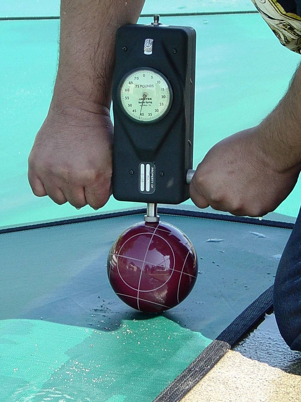 compression test of pool cover using a spring pressure mechanical force gauge