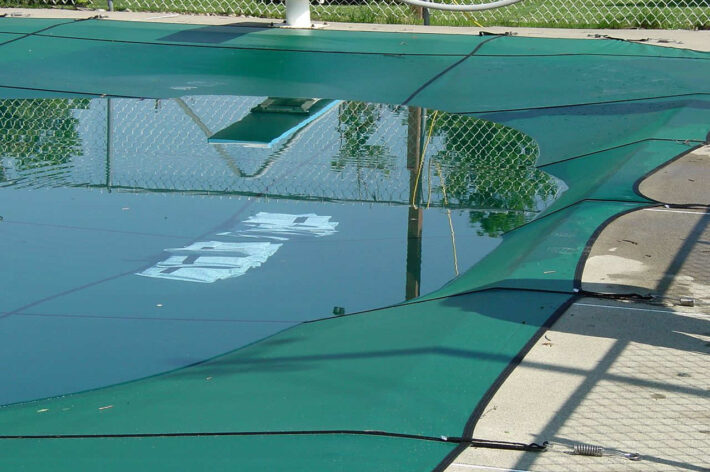 pool cover tested using compression from weight and water to represent snow during the winter months to test for durability