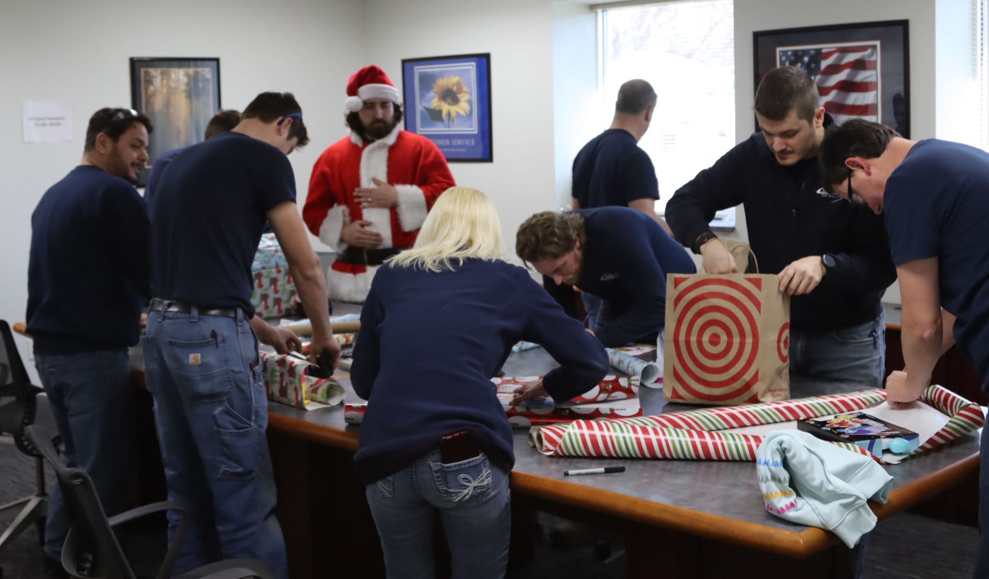 the Innovative Test Solutions engineering team wrapping gifts for two families in Schenectady to donate during the holiday season