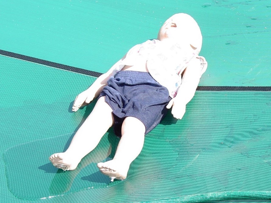 child-sized dummy used in compression testing for the safety and durability of residential pool covers