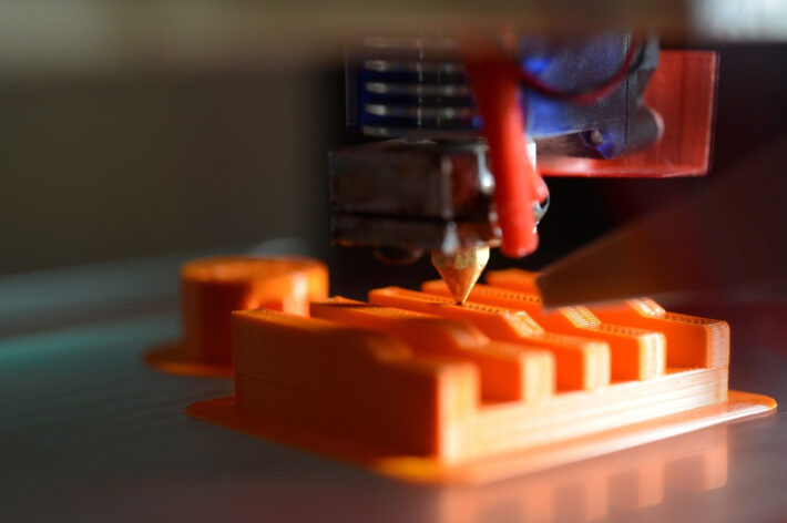 3D printing in action with a polymer part manufactured via FDM printing