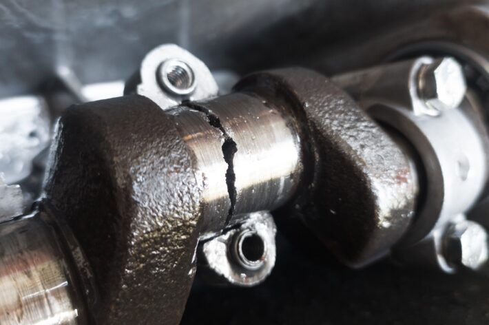 A closeup view of fatigue-related cracks in an engine crankshaft